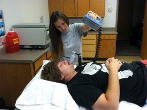 Student demonstrating a valsalva maneuver.