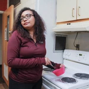 Allen Hall kitchen with student preparing food