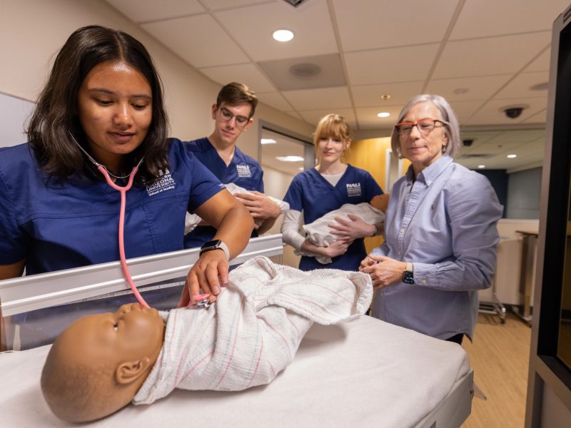 A nursing student uses a stethoscope during their studies
