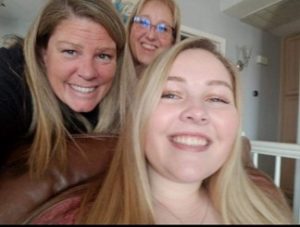 Cora and two women smiling and taking a selfie