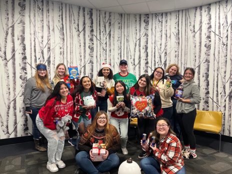 Transfer Jacks Team smiling at camera, dressed in holiday sweaters.
