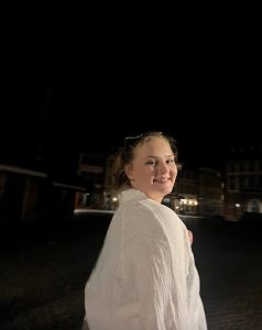 Megan in a white shirt smiling at camera