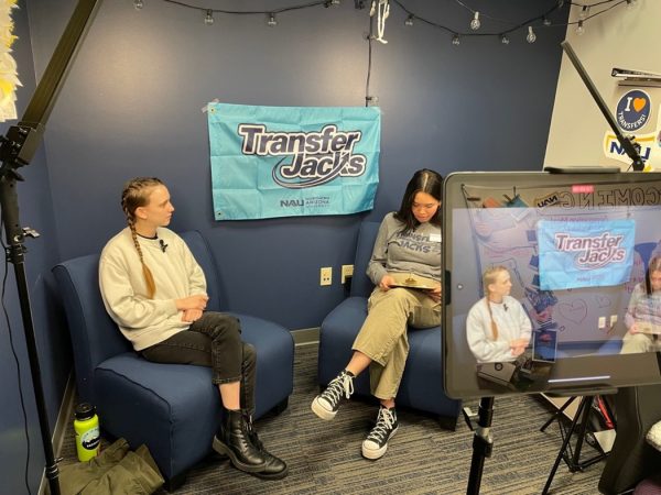 Two people sitting in armchairs with recording equipment