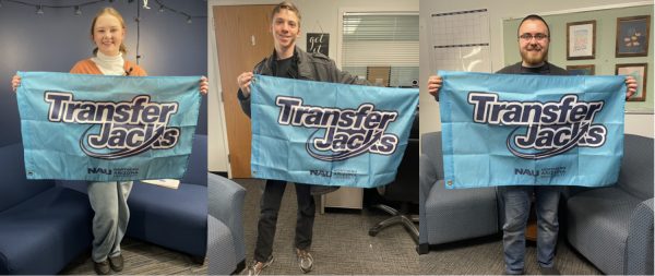 Three transfer student smiling at camera holding blue Transfer Jacks flags
