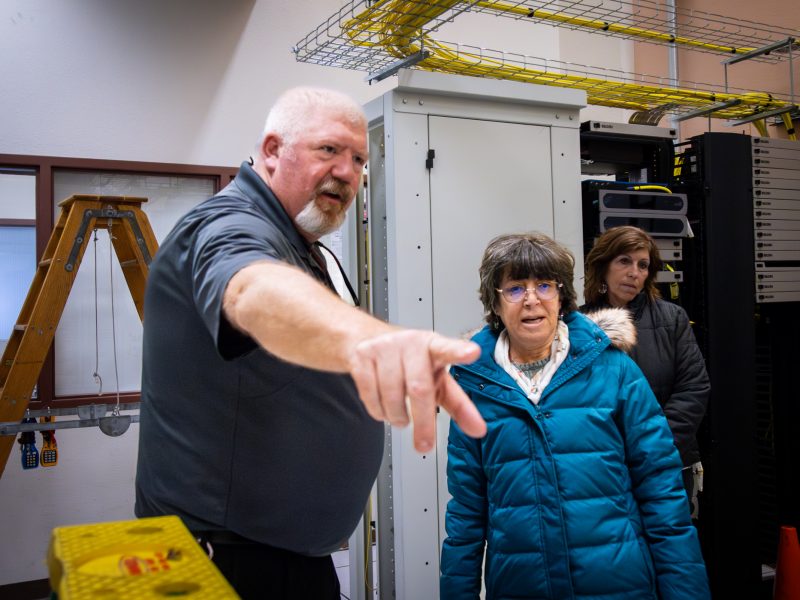 Brett West shows Cathy Propper a component of the server room update