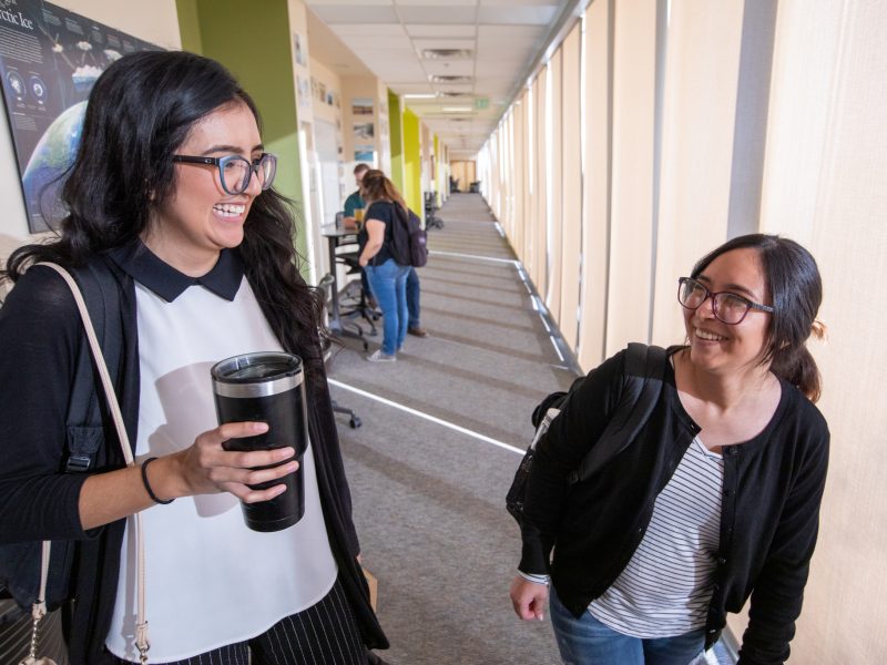 Two students sitting outside at N A U&ndash;Yuma campus.