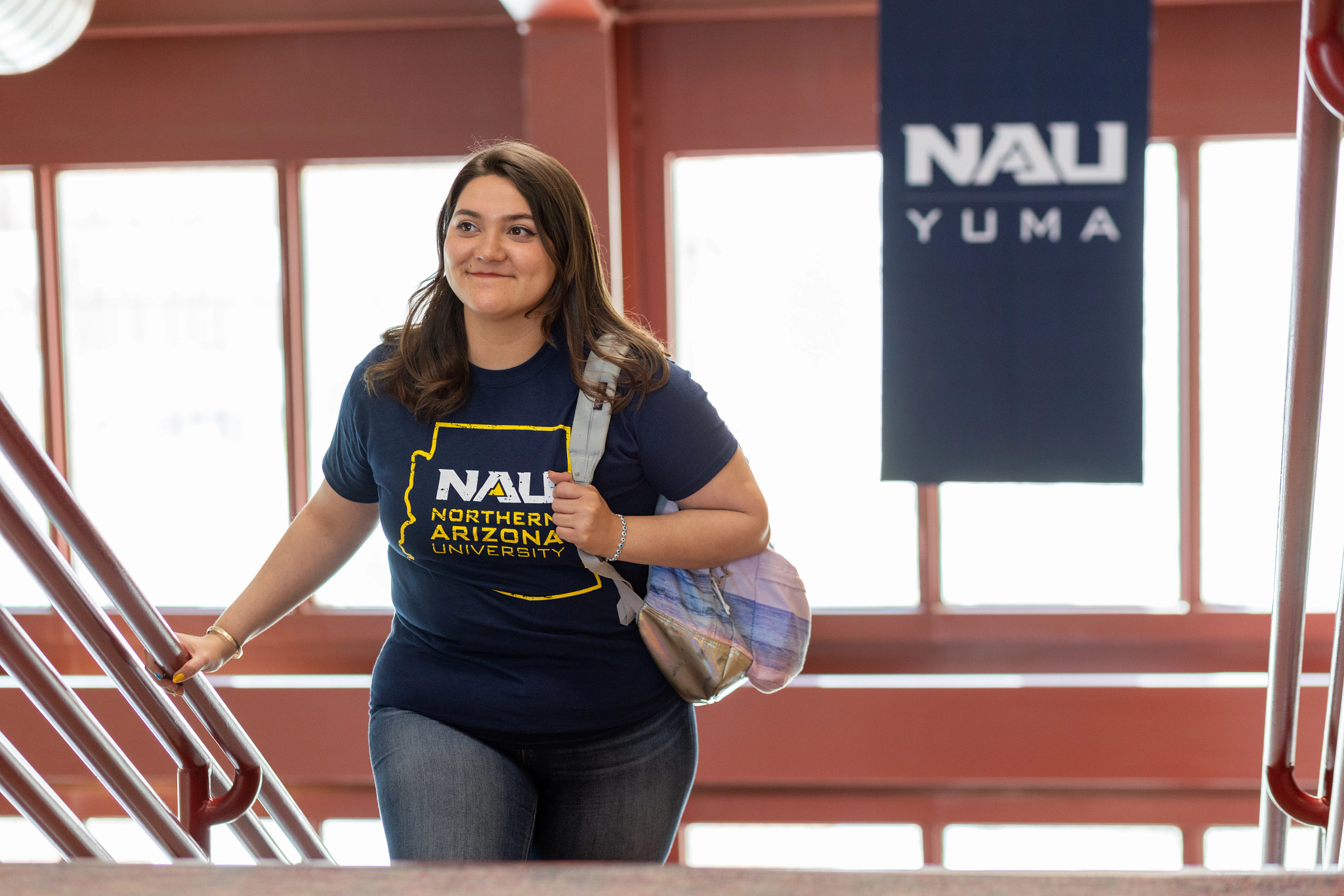 N A U–Yuma student walking up staircase.