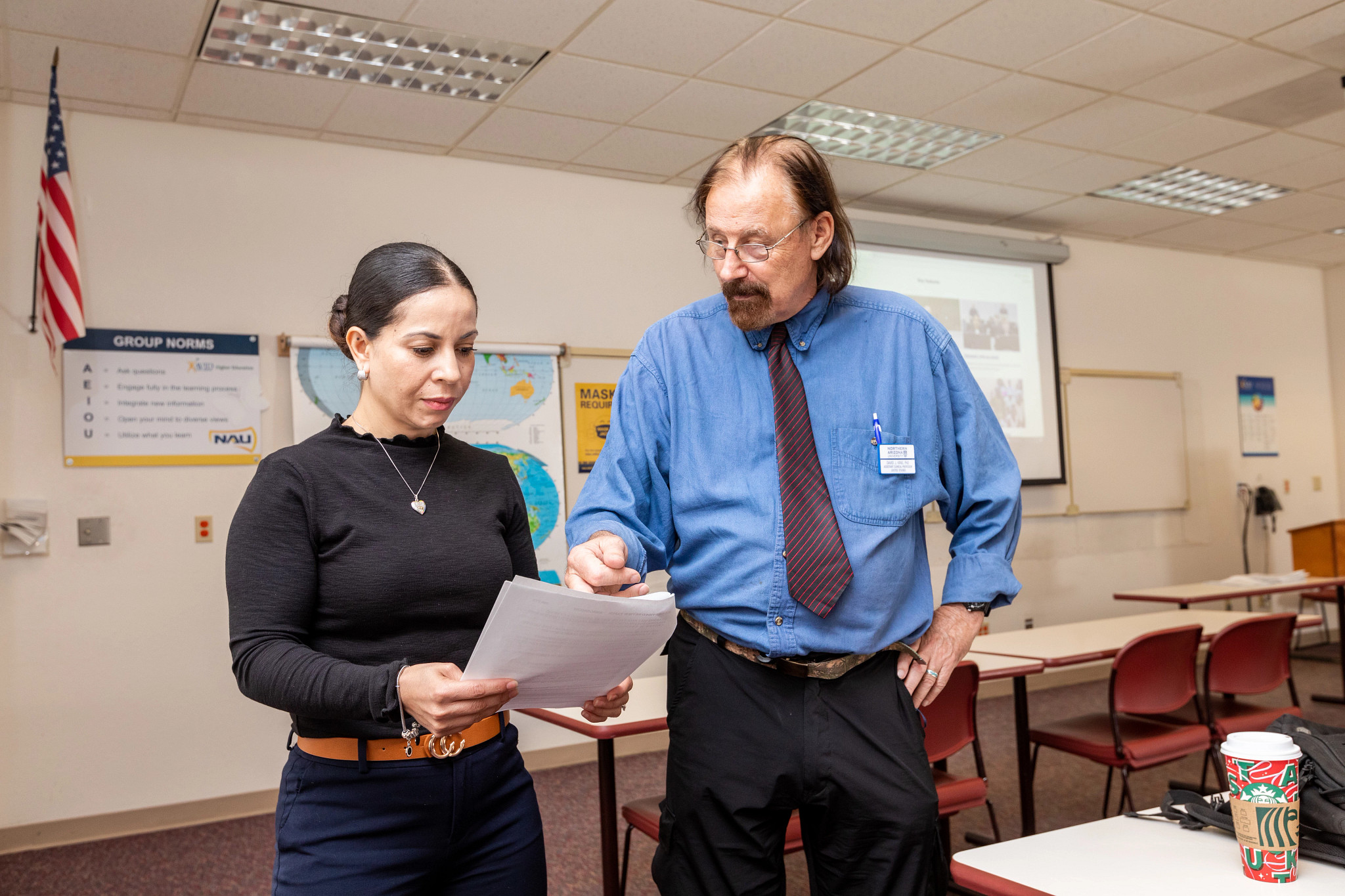 N A U–Yuma professor helping a student with work.