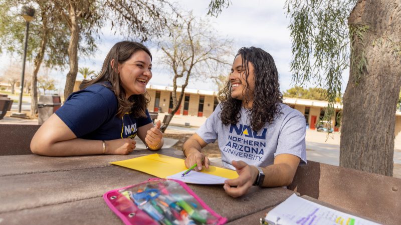 N A U–Yuma students working together outside.