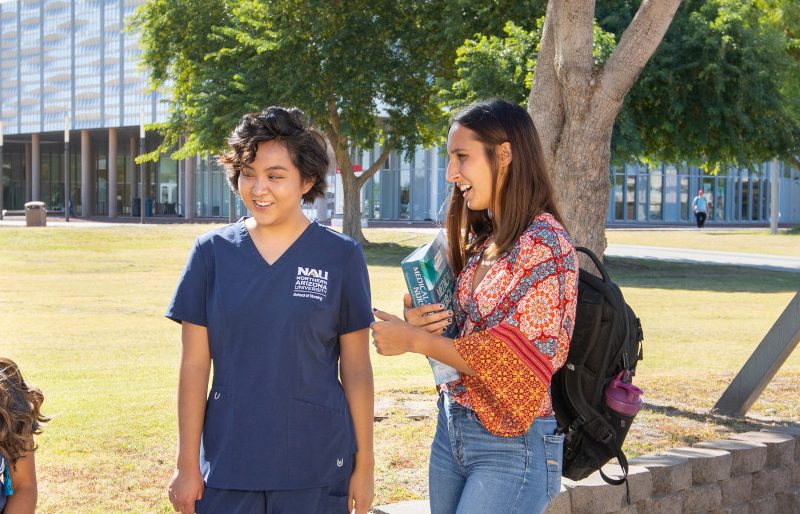 Students sitting outside on N A U–Yuma campus.
