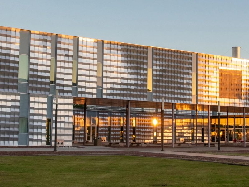 N A U–Yuma building with the sunshine reflecting from the it's panels.
