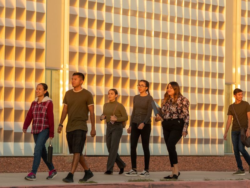 Students walk together and chat on campus.