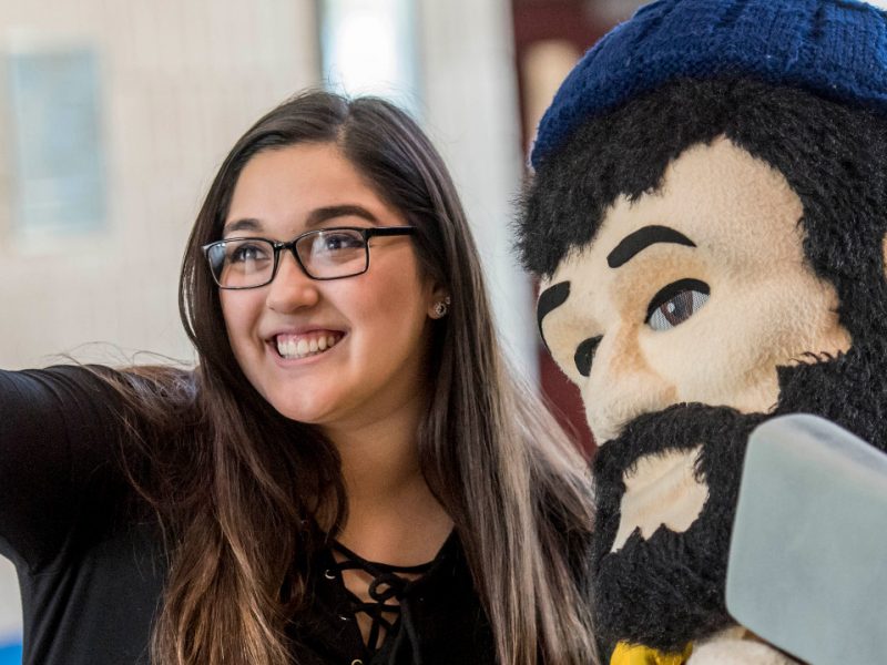 N A U–Yuma student taking aselfie with Louie the Lumberjack.