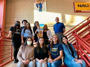 Students posing and celebrating their teacher.